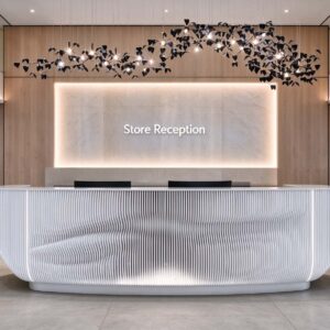 White curved fluted reception desk with LED lighting at store reception
